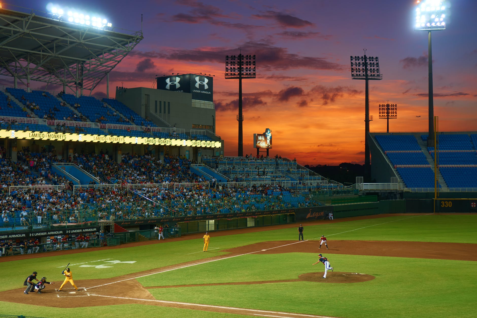 Sky view of baseball field with professional athletes playing.