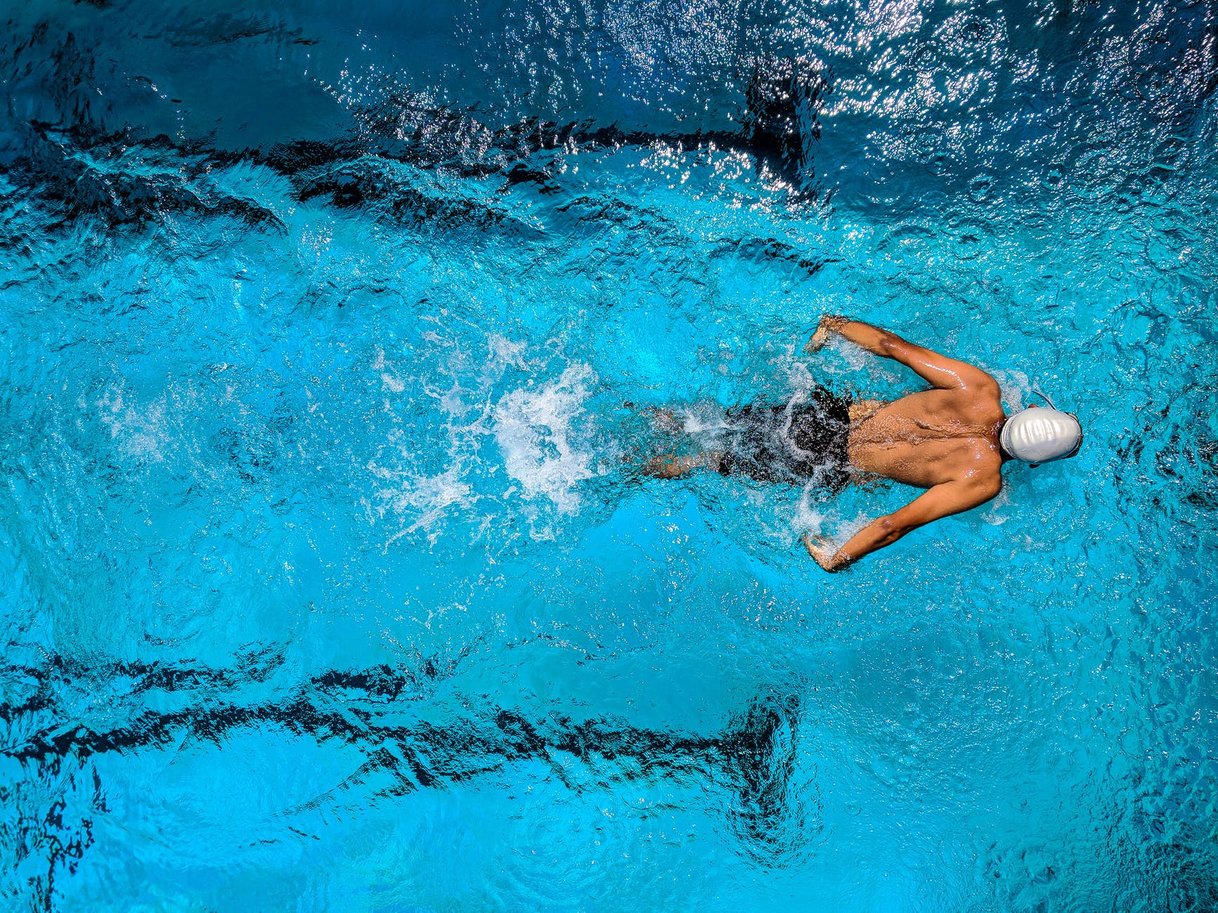Swimmer in water, representing sports athletes.